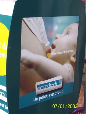 Point de ravitaillement - ad picture of a baby looking at mom with a smile, just coming off mother's nipple after nursing