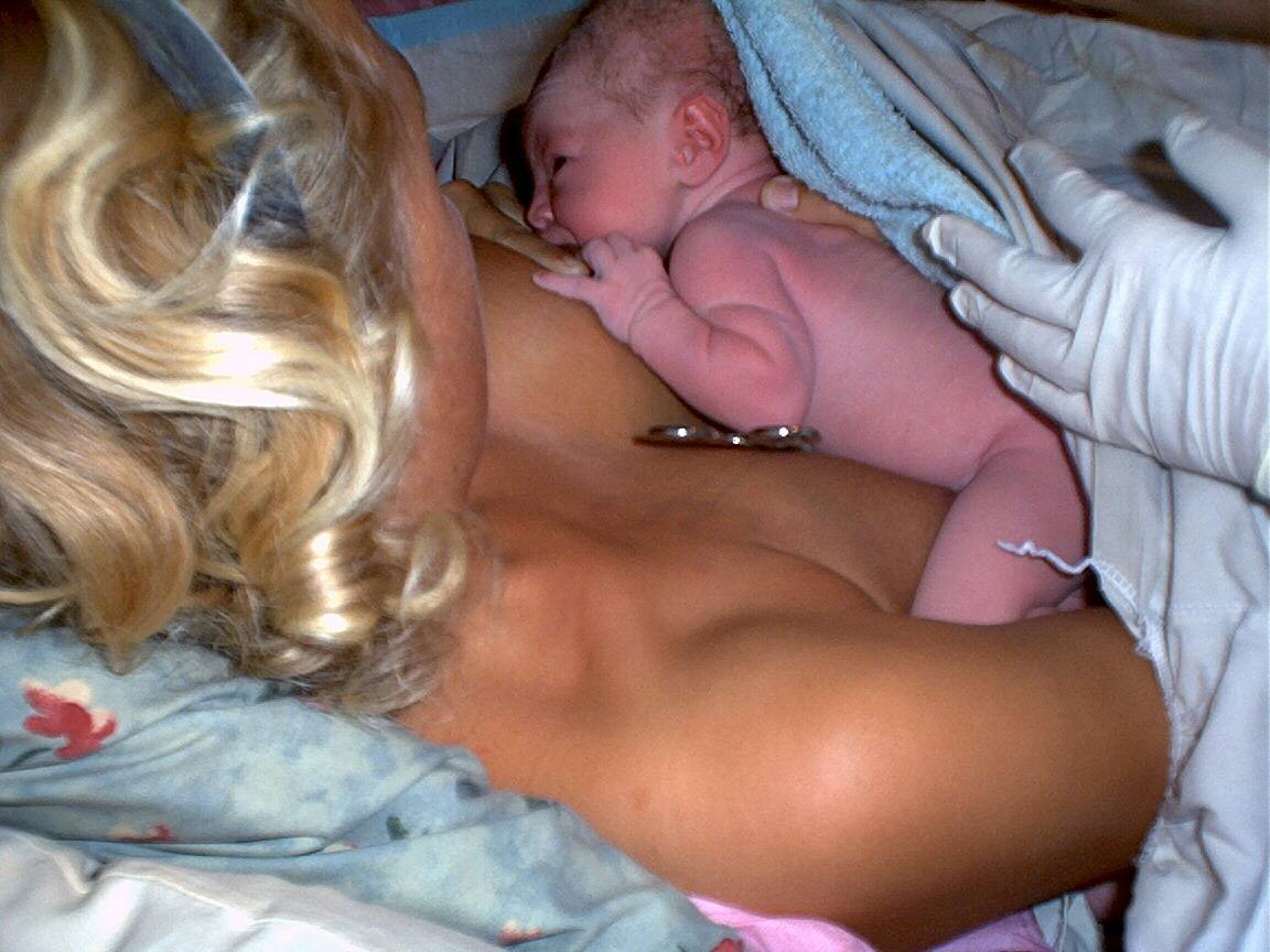 newborn baby on mom's chest nursing
