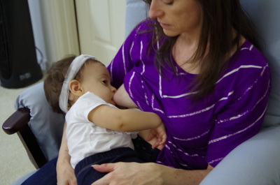 A one-year old girl nursing
