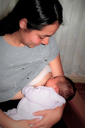 Young woman nursing a small baby