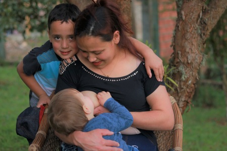 toddler nursing, older brother watching